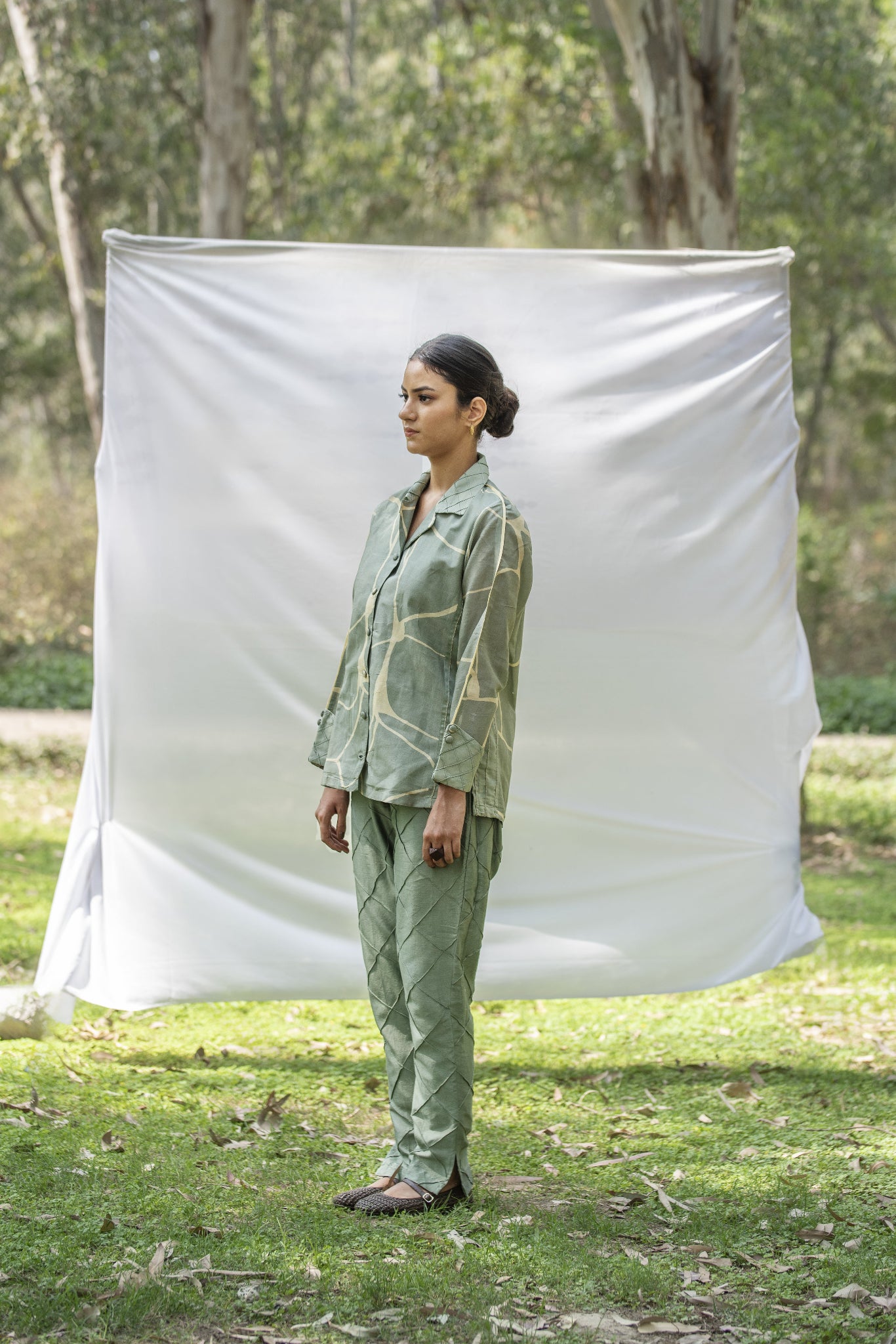 Luxury shirt and trouser set with Kantha embroidery
Designer Chanderi Silk outfit with diamond pin tuck detailing
Elegant olive green occasion wear by Riiti
Handcrafted Chanderi Silk co-ord set with side pocket trousers